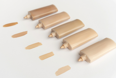Various foundation shades containing dimethicone lined up — examining silicone’s role in makeup and skincare.
