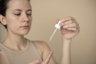 Applying glycolic acid serum as part of evening exfoliation routine