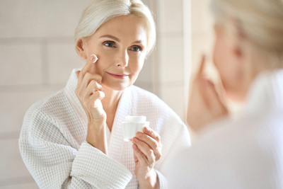 Mature woman applying peptide cream for anti-aging skincare routine