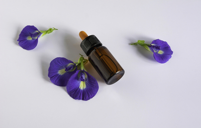 Bakuchiol serum bottle with butterfly pea flowers – natural retinol alternative for anti-aging skincare
