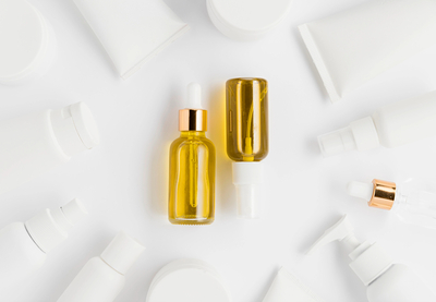 Vitamin C + ferulic acid antioxidant serum in amber dropper bottles — stabilized brightening formula for dark spots and anti-aging skincare.